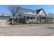 View of two-story home with fenced front yard and nearby garage at 408 E Beecher St, Indianapolis, IN 46225