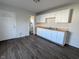 Kitchen with white cabinets, wood countertops, and access to a bathroom at 408 E Beecher St, Indianapolis, IN 46225