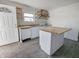 Kitchen with an island, white cabinets and open wood shelving at 408 E Beecher St, Indianapolis, IN 46225