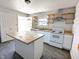 Open kitchen featuring an island, stainless vent hood, and open shelving at 408 E Beecher St, Indianapolis, IN 46225