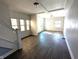 Inviting living room boasts hardwood floors, many windows and white trim at 408 E Beecher St, Indianapolis, IN 46225