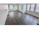 An empty living room space featuring hardwood flooring, white paint and natural lighting at 408 E Beecher St, Indianapolis, IN 46225