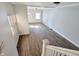 Bright living room with wood-look floors, staircase, and natural light at 408 E Beecher St, Indianapolis, IN 46225