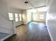Bright living room featuring wood-look floors and multiple windows at 408 E Beecher St, Indianapolis, IN 46225