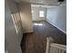 Bright living room boasts hardwood floors, lots of windows, and neutral paint at 408 E Beecher St, Indianapolis, IN 46225
