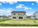 Expansive backyard showcases a well-maintained lawn and beige, two-story home at 4087 Railhead Ave, Westfield, IN 46074
