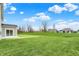 Large backyard with green grass and a view of siding on the two-story home at 4087 Railhead Ave, Westfield, IN 46074