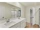 This bathroom features a double sink vanity, a large mirror, a walk-in closet, and a glass-enclosed shower at 4087 Railhead Ave, Westfield, IN 46074