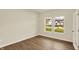 Bright bedroom featuring wood floors, two windows, and a door with glass inlays for natural light at 4087 Railhead Ave, Westfield, IN 46074