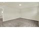 This bedroom features plush carpeting, neutral paint, and a door leading to another room at 4087 Railhead Ave, Westfield, IN 46074
