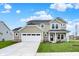 Charming two-story home with a manicured lawn and a two-car garage and inviting covered front porch at 4087 Railhead Ave, Westfield, IN 46074