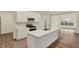 Bright kitchen featuring white cabinets, stainless steel appliances, island, and a view to the yard at 4087 Railhead Ave, Westfield, IN 46074