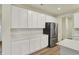 Bright kitchen featuring white cabinets, quartz countertops and stainless steel appliances, and wood flooring at 4087 Railhead Ave, Westfield, IN 46074