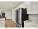 Well-lit kitchen with white cabinets, stainless steel refrigerator, and quartz countertops at 4087 Railhead Ave, Westfield, IN 46074