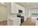 Clean kitchen with white cabinets, stainless steel stove, and ample countertop space at 4087 Railhead Ave, Westfield, IN 46074
