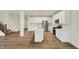 A modern kitchen with stainless steel appliances, white cabinets and a large island with wood flooring at 4087 Railhead Ave, Westfield, IN 46074