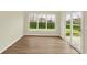 Bright living room featuring hardwood floors, large windows, and a sliding glass door showcasing the outdoor scenery at 4087 Railhead Ave, Westfield, IN 46074