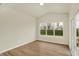 Bright living room featuring hardwood floors, large windows, and a sliding glass door showcasing the outdoor scenery at 4087 Railhead Ave, Westfield, IN 46074