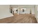 Open-concept living area connecting to the kitchen, featuring hardwood floors and a staircase at 4087 Railhead Ave, Westfield, IN 46074
