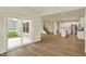 Open-concept living area with hardwood floors leading to the kitchen, island, stainless appliances, and a staircase at 4087 Railhead Ave, Westfield, IN 46074