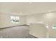 A spacious loft provides an additional living area, featuring windows and neutral carpeting at 4087 Railhead Ave, Westfield, IN 46074