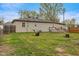 Spacious backyard with a lush lawn, a convenient lawnmower, and a wooden patio area at 409 W Pike St, Martinsville, IN 46151