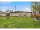 Large backyard featuring a well-kept lawn and wooden patio area, perfect for outdoor activities at 409 W Pike St, Martinsville, IN 46151