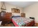 Bedroom featuring hardwood floors, a quilt bed, wooden furniture and unique wall decorations at 409 W Pike St, Martinsville, IN 46151