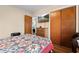 Bedroom featuring hardwood floors, a view of a TV, a closet and a comfortable bed at 409 W Pike St, Martinsville, IN 46151