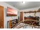 Bedroom with a TV on the wall, a comfortable bed, hardwood floors and wooden shelves at 409 W Pike St, Martinsville, IN 46151