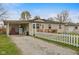 Charming home with a white picket fence, a covered carport and a welcoming front porch at 409 W Pike St, Martinsville, IN 46151