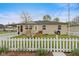 Charming single-story home featuring a front porch, white picket fence, and well-maintained lawn at 409 W Pike St, Martinsville, IN 46151