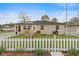 Charming single-story home with a welcoming front porch and a classic white picket fence at 409 W Pike St, Martinsville, IN 46151