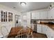 Efficient kitchen featuring white cabinets, stainless steel appliances, and a breakfast nook at 409 W Pike St, Martinsville, IN 46151