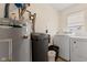 Functional laundry room with modern washer, dryer and a water softener system for added convenience at 409 W Pike St, Martinsville, IN 46151
