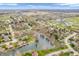 Panoramic aerial view of a residential neighborhood with tree-lined streets and a serene lake in the center at 454 Roberson Blvd, Mooresville, IN 46158