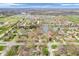 Aerial view of a well-planned residential community with a pond and shopping centers in the distance at 454 Roberson Blvd, Mooresville, IN 46158
