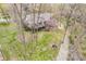 Expansive backyard featuring mature trees, lush greenery, and a charming fire pit area at 454 Roberson Blvd, Mooresville, IN 46158
