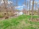 Picturesque backyard with lush lawn, lake access, and inviting fire pit area at 454 Roberson Blvd, Mooresville, IN 46158