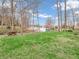Scenic backyard with a vibrant lawn, mature trees, and serene lake views enhancing the property's appeal at 454 Roberson Blvd, Mooresville, IN 46158