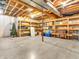 Unfinished basement with exposed wood beams, concrete floor, storage shelves, and Christmas tree at 454 Roberson Blvd, Mooresville, IN 46158
