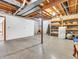 Unfinished basement area with exposed beams, concrete floor, shelving, support beam and wall at 454 Roberson Blvd, Mooresville, IN 46158