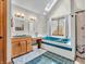 Bright bathroom featuring a skylight, soaking tub, double vanity, and tiled floors at 454 Roberson Blvd, Mooresville, IN 46158