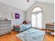 Bedroom featuring a twin bed, wood floors, bright window and a gray dresser at 454 Roberson Blvd, Mooresville, IN 46158