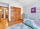 Bedroom featuring a twin bed, wood floors, wall decor and an attached bathroom at 454 Roberson Blvd, Mooresville, IN 46158
