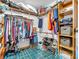 Walk-in closet with wood shelving and racks, organized clothing, and green tiled floors at 454 Roberson Blvd, Mooresville, IN 46158