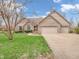 Charming brick home with attached two car garage and lush green lawn at 454 Roberson Blvd, Mooresville, IN 46158