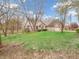 Brick home featuring a spacious front yard, mature trees, landscaping, and a three-car garage at 454 Roberson Blvd, Mooresville, IN 46158