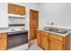 Functional kitchen featuring wood cabinets, tiled floors, and a sink with countertop space at 454 Roberson Blvd, Mooresville, IN 46158