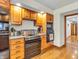 Kitchen with stainless steel appliances, oak cabinets, and hardwood flooring at 454 Roberson Blvd, Mooresville, IN 46158